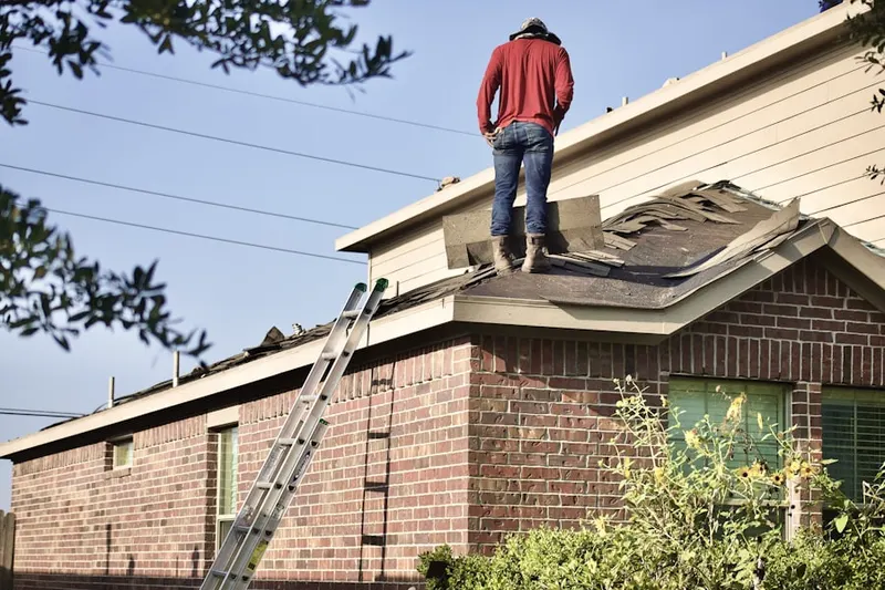 Professional roofer working on a residential roof in Thomas Mills